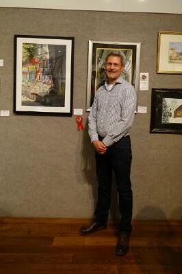 Tom Schroeder posing with his 2nd place painting